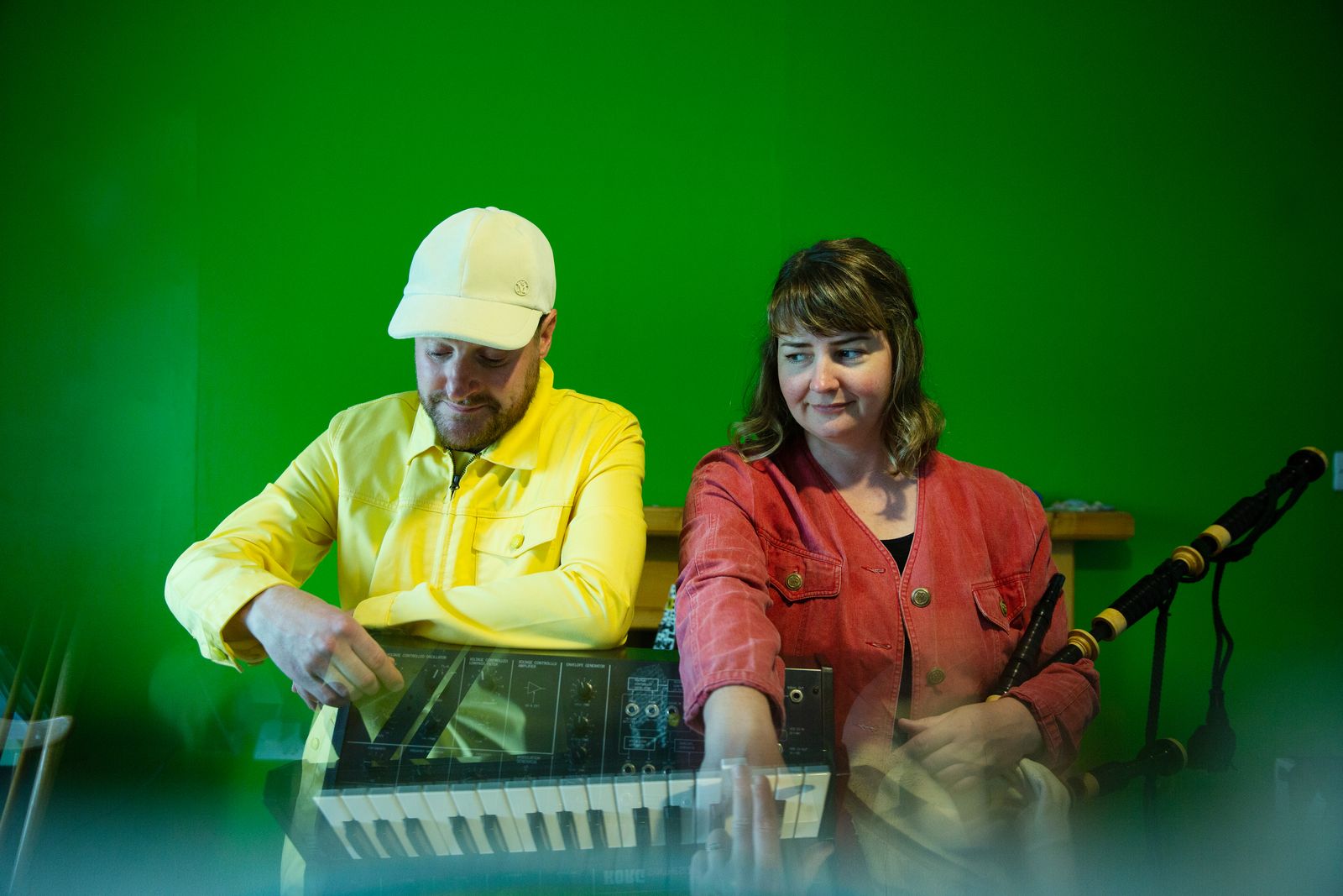 Mike Vass and Mairearad Green at a Korg synthesiser, with Highland pipes on a stand beside them