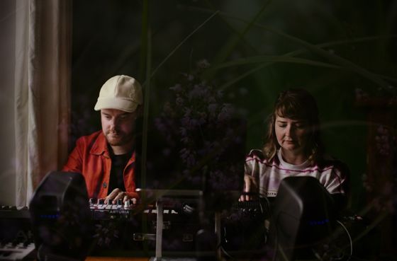 Mike and Mairearad at their synthesisers, with heather laid over the picture