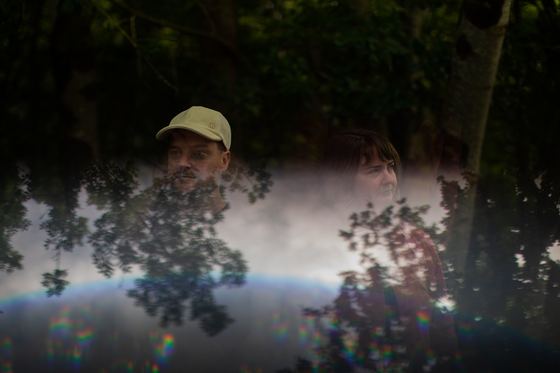 Mike and Mairearad, with trees reflected over them